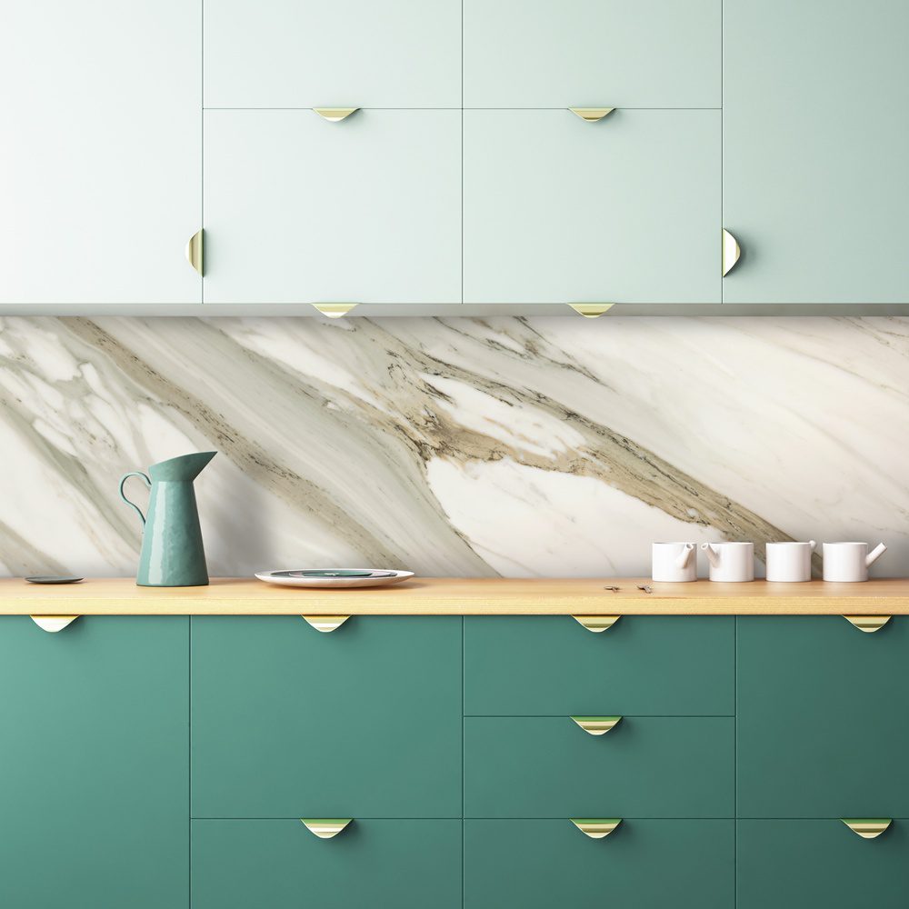 Pale green and dark green cabinets with a countertop and porcelain backsplash